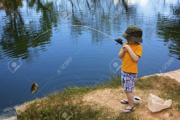 Little Boy Catching A Fish Stock Photo, Picture And Royalty Free Image.  Image 19385327.
