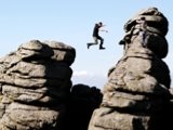 Photo: Man jumping between rocks