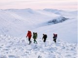 Photo: Hikers crossing snowy mountain peaks